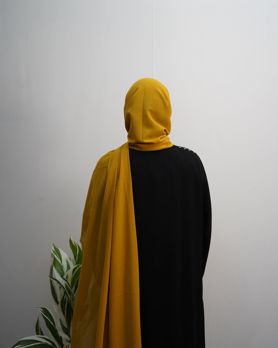 Mustard yellow chiffon hijab with lightweight breathable fabric and soft drape.