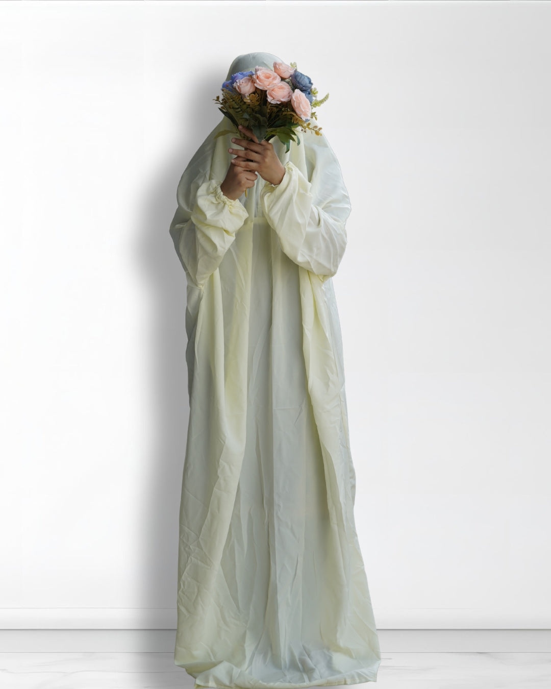 Off white Islamic prayer dress full length front view with floral bouquet.
