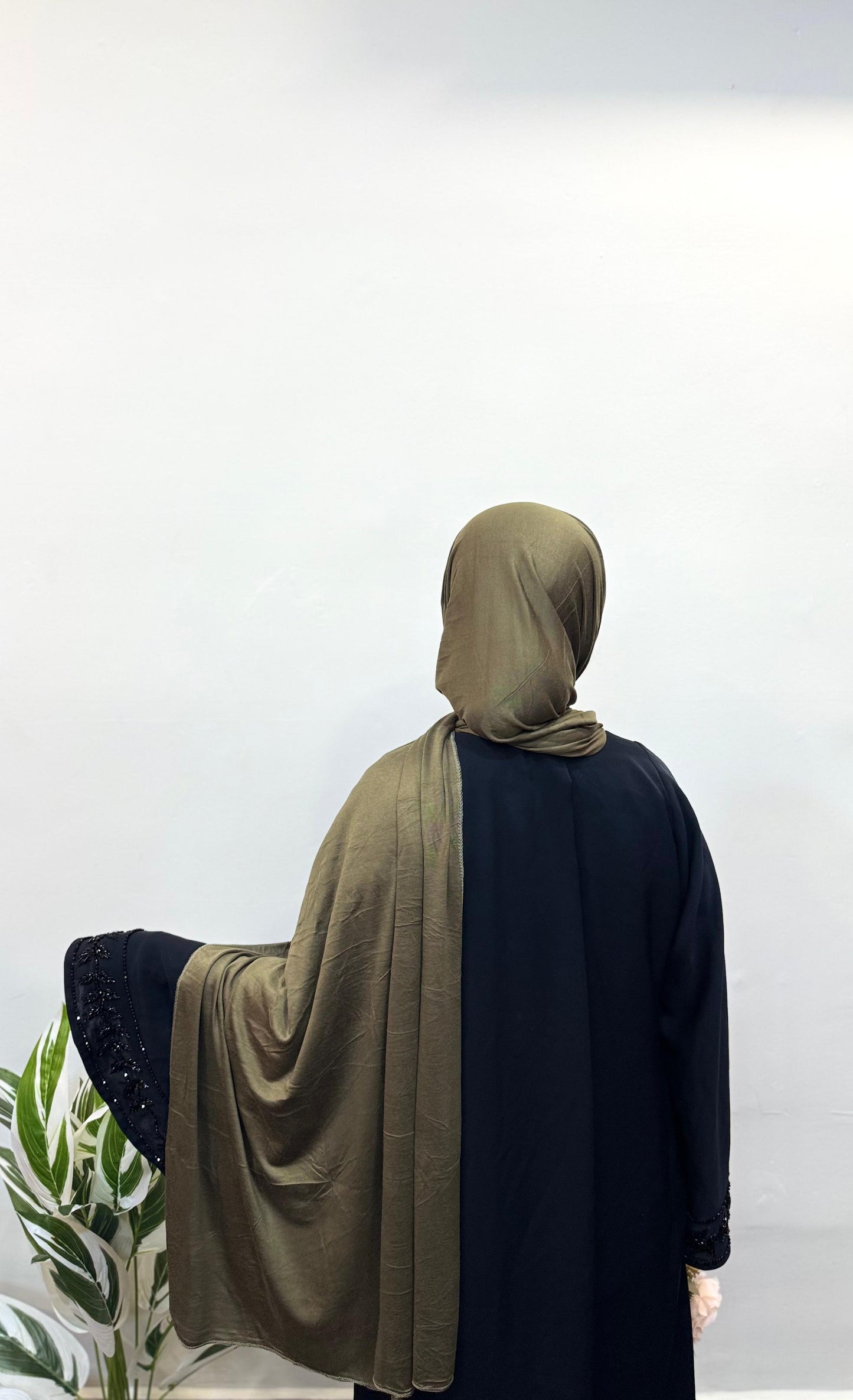 Olive green jersey hijab styled for a casual look.