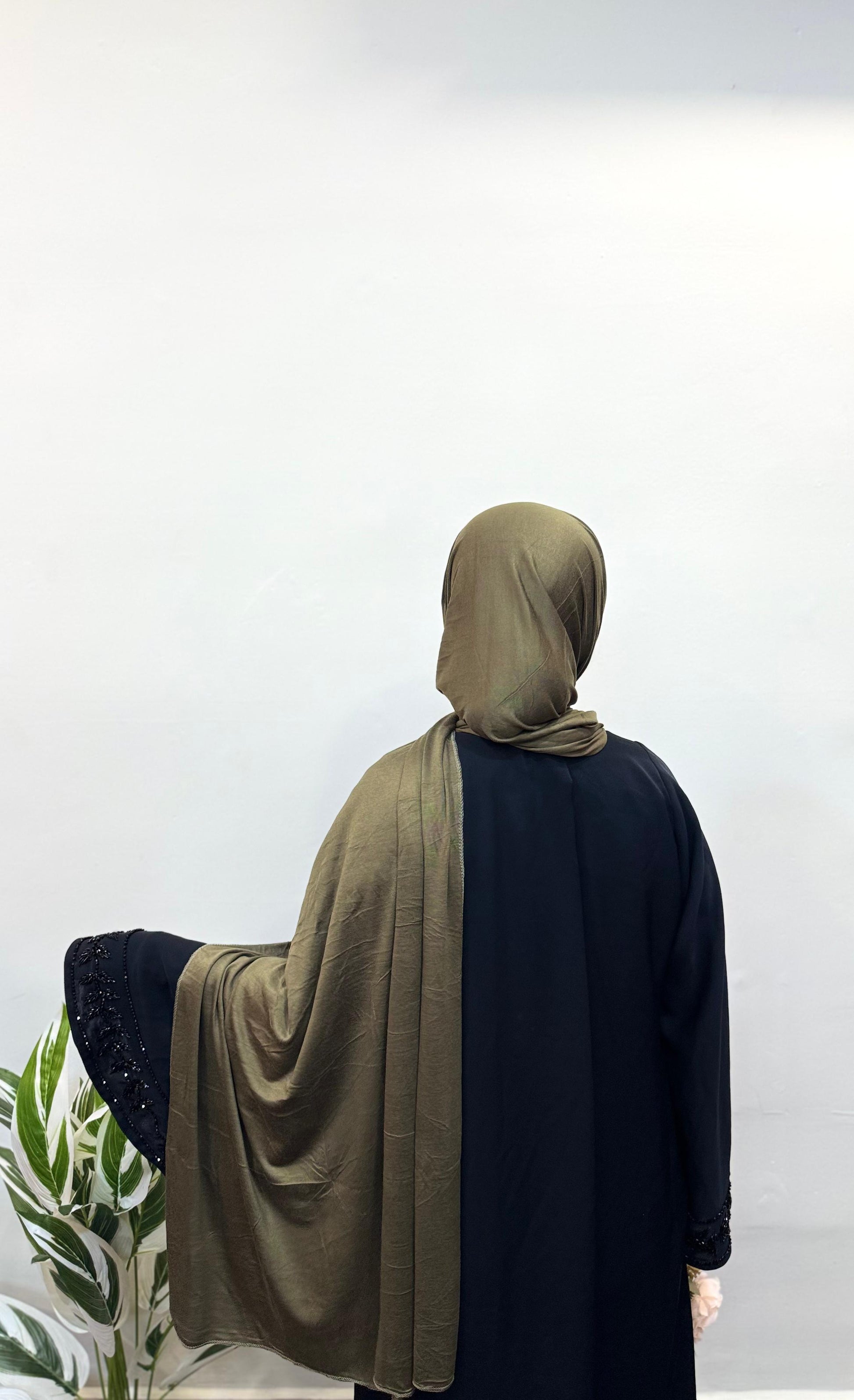Olive green jersey hijab styled for a casual look.