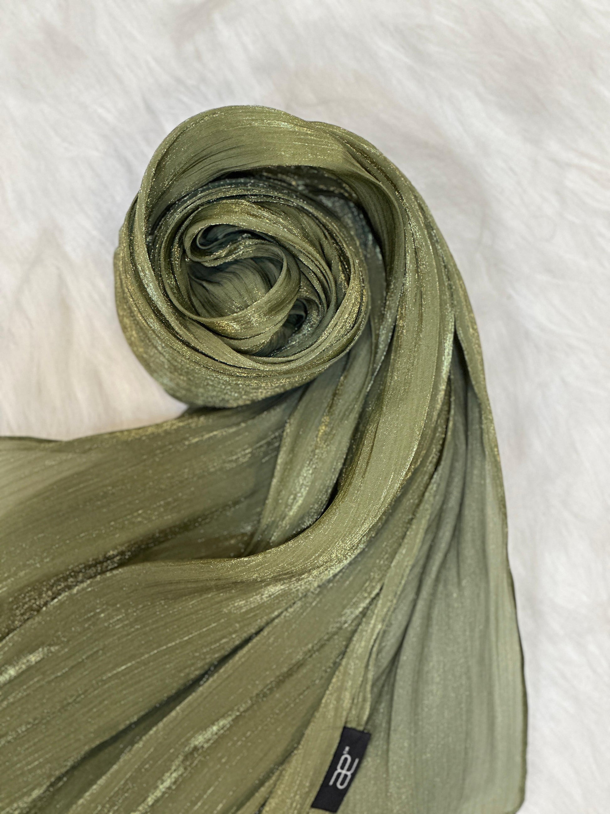 Circular display of the Olive Green Shimmer Hijab showing light shine.