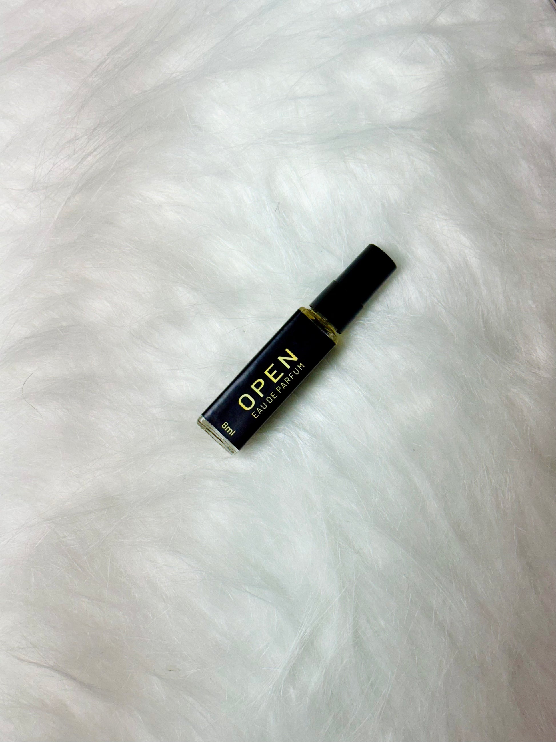 Open Sample 8ml bottle lying flat on a white surface.