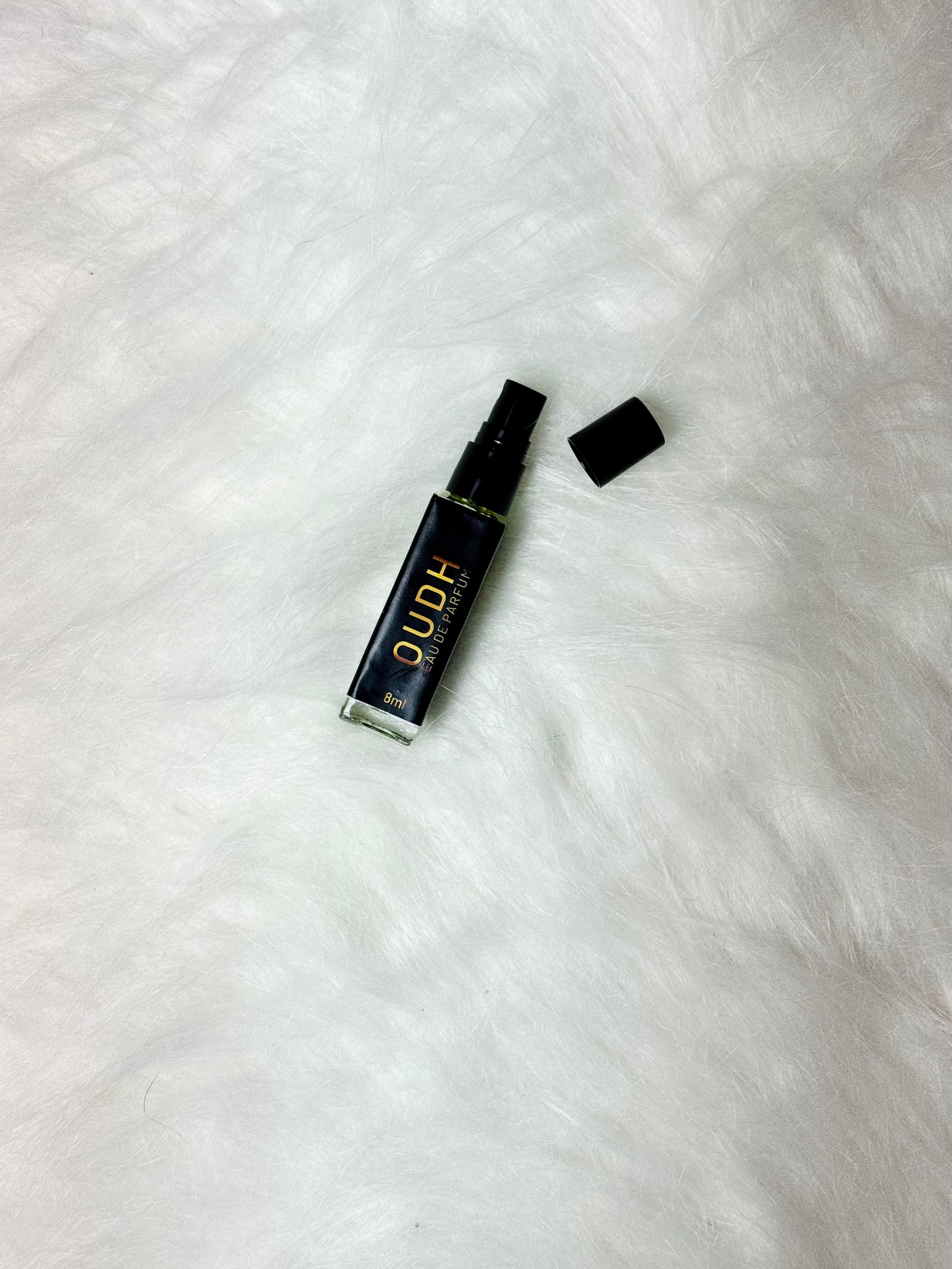 Flat Oudh Perfume 8ml bottle shown with the lid removed on white.