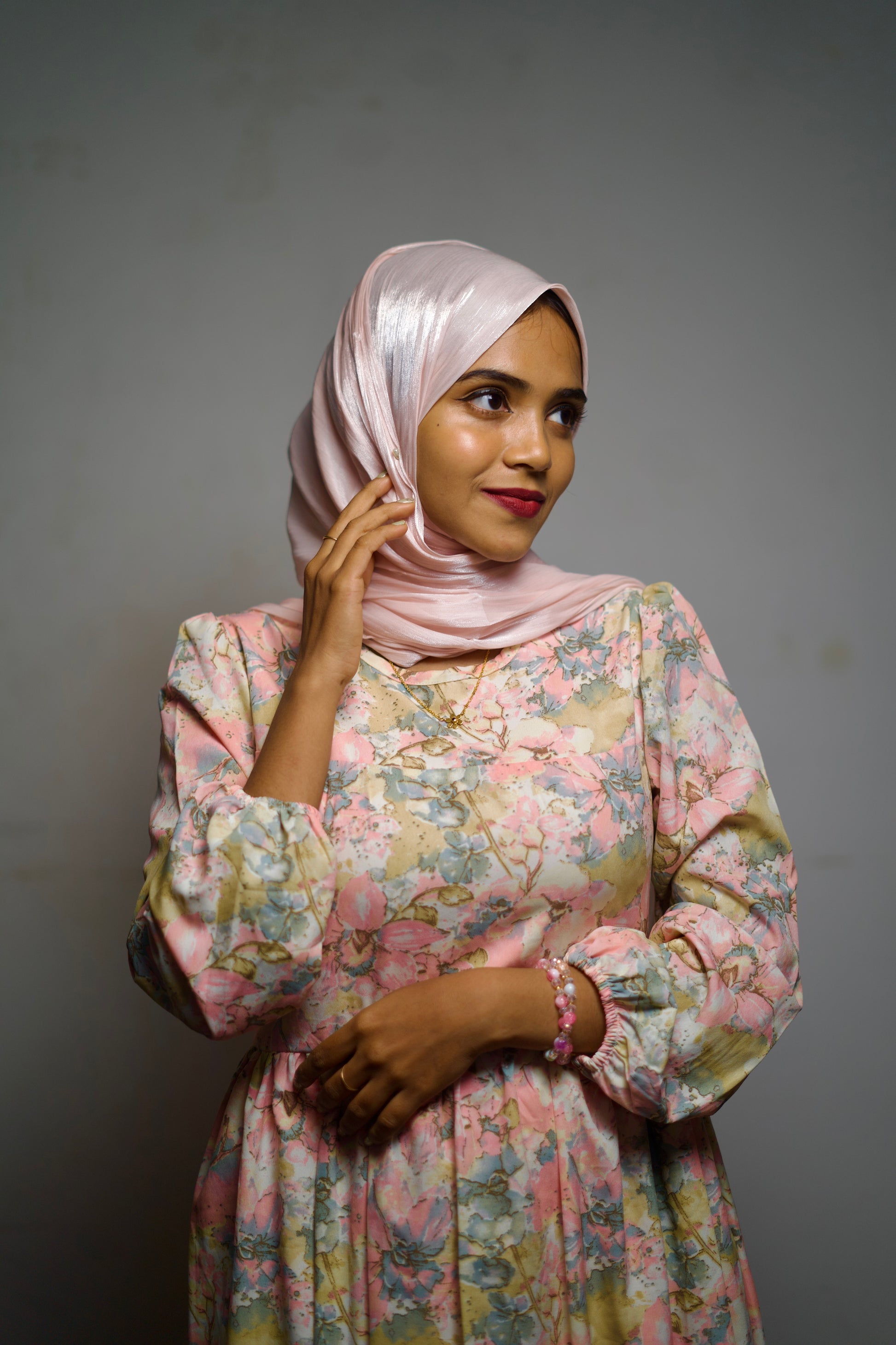 Soft pastel shimmer hijab draped gently around the face with a clean edge.