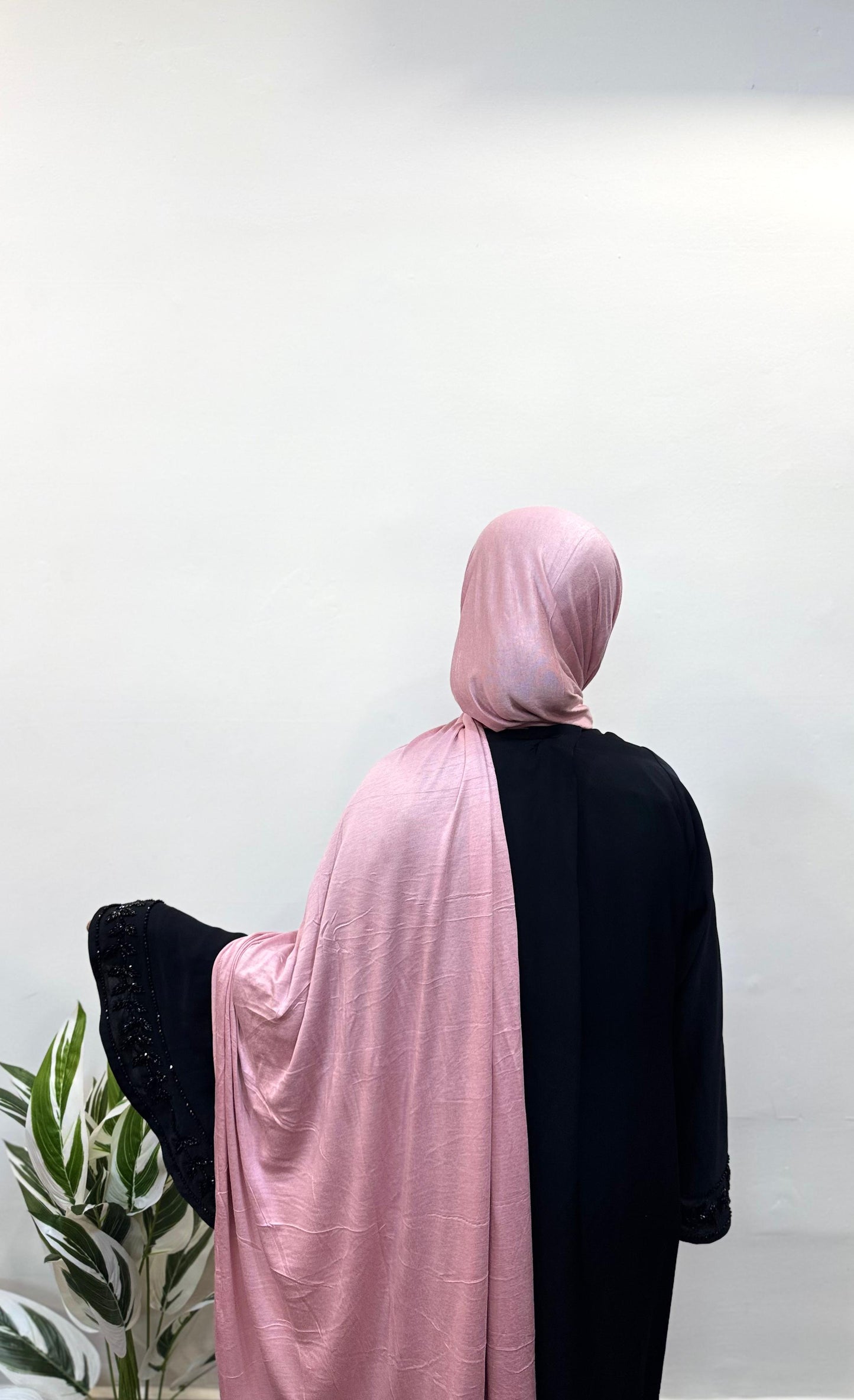 Pink jersey hijab wrapped neatly for a simple, chic look.