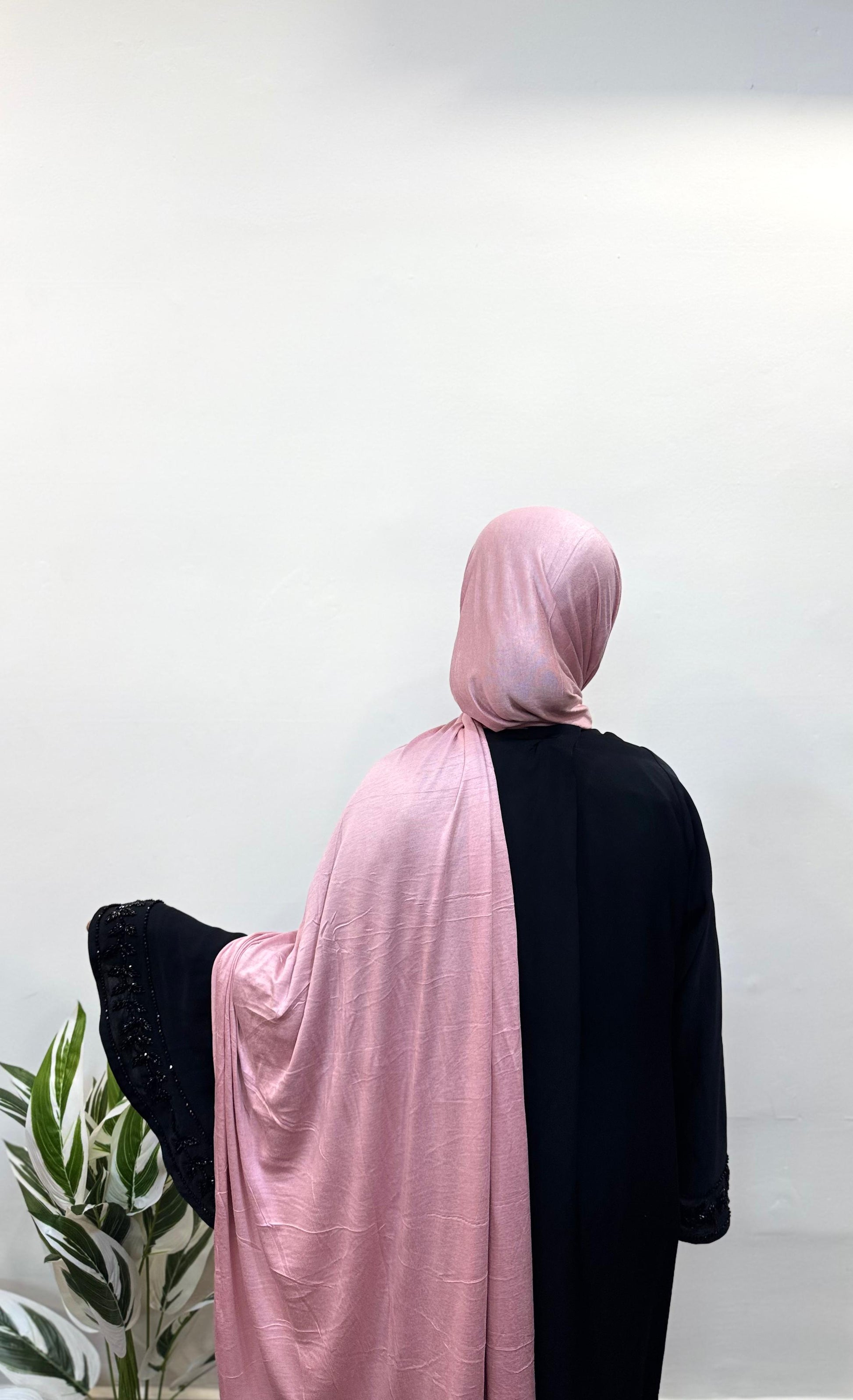 Pink jersey hijab wrapped neatly for a simple, chic look.