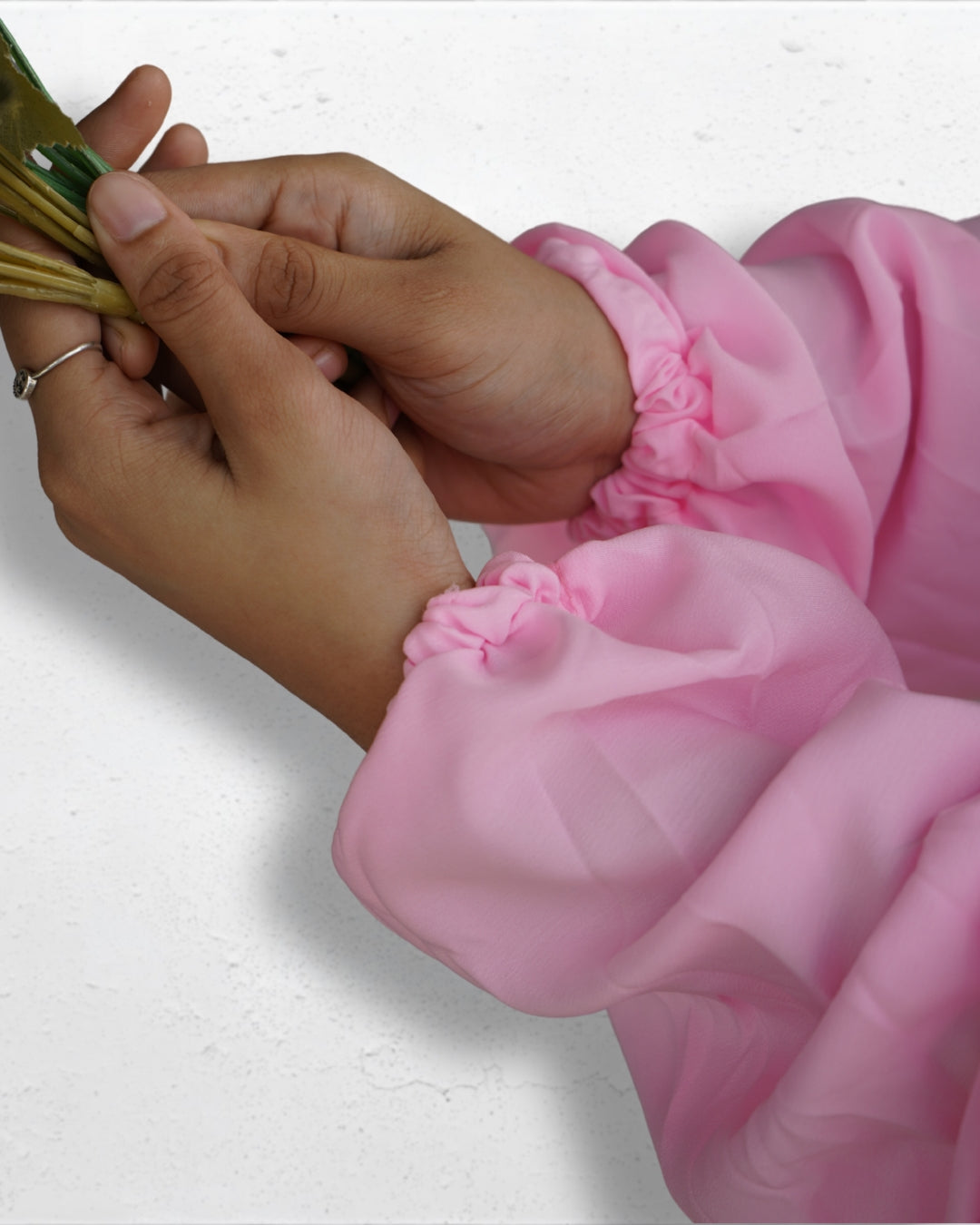 Elastic cuff detail of solid pink modest prayer dress sleeve.