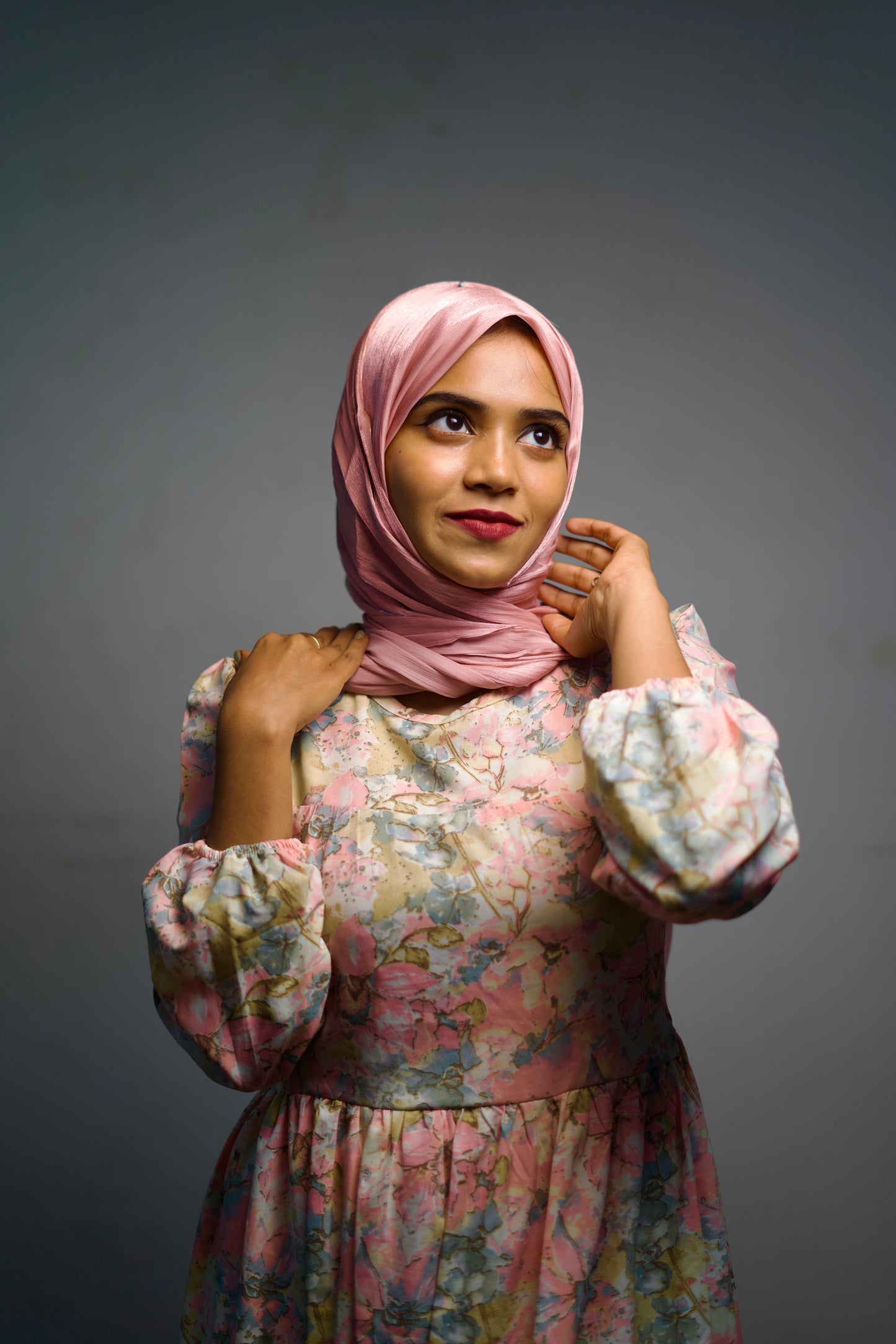 Pink shimmer scarf with soft folds, worn in an easy wrap.