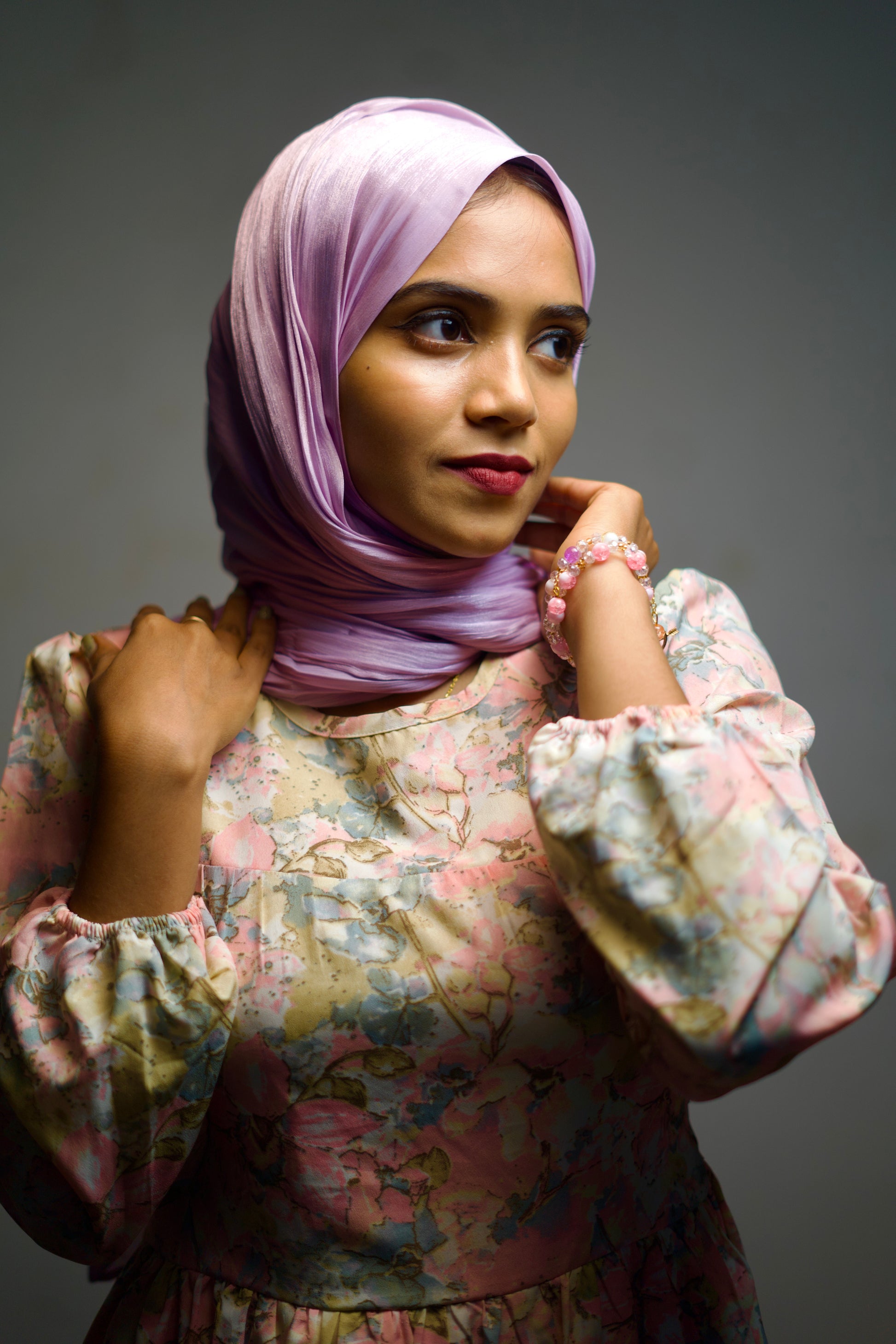 Plum shimmer scarf worn with clean folds and a smooth, radiant finish.