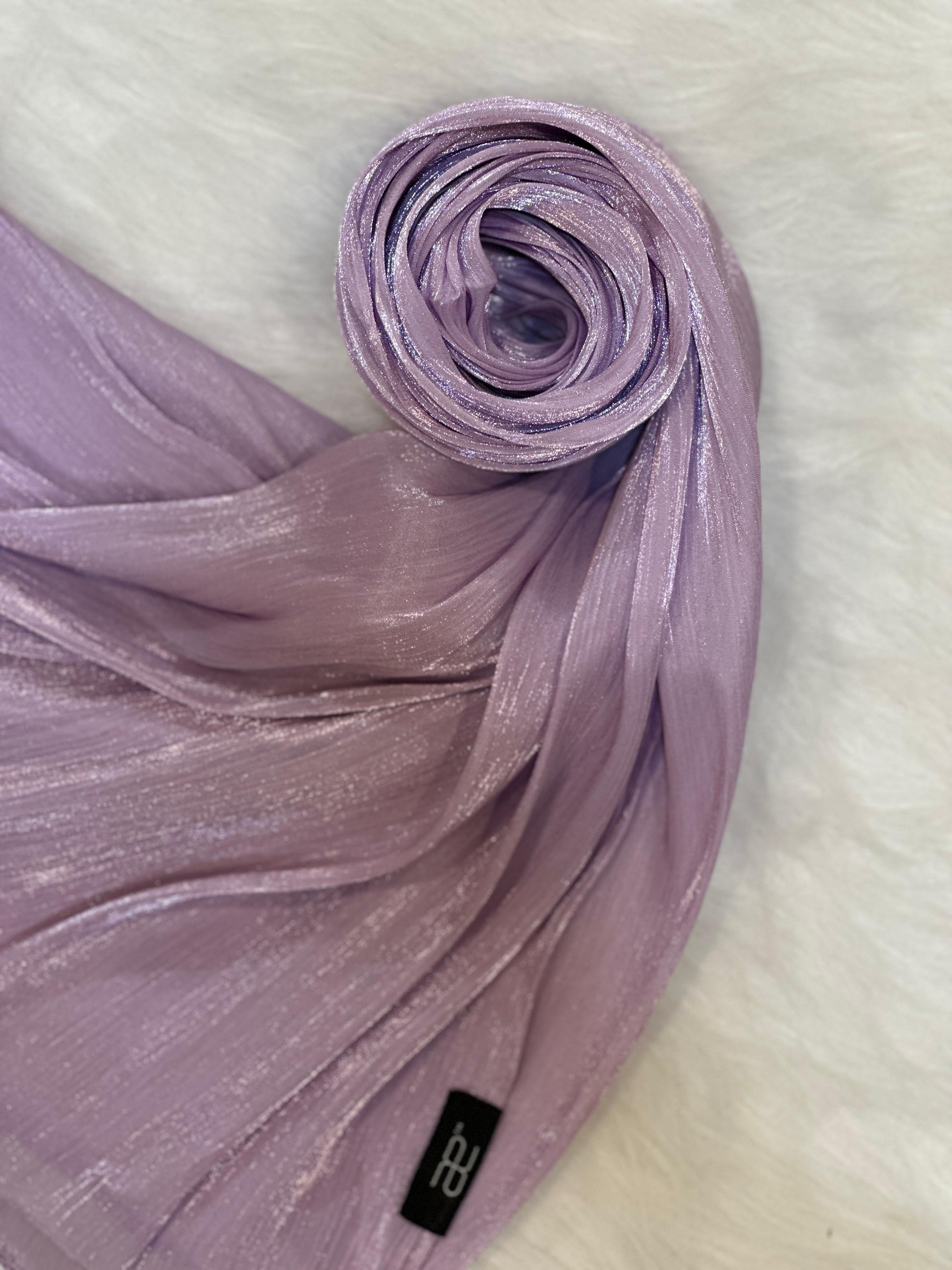 Rolled chiffon scarf in plum shimmer, displayed in a neat circular shape.