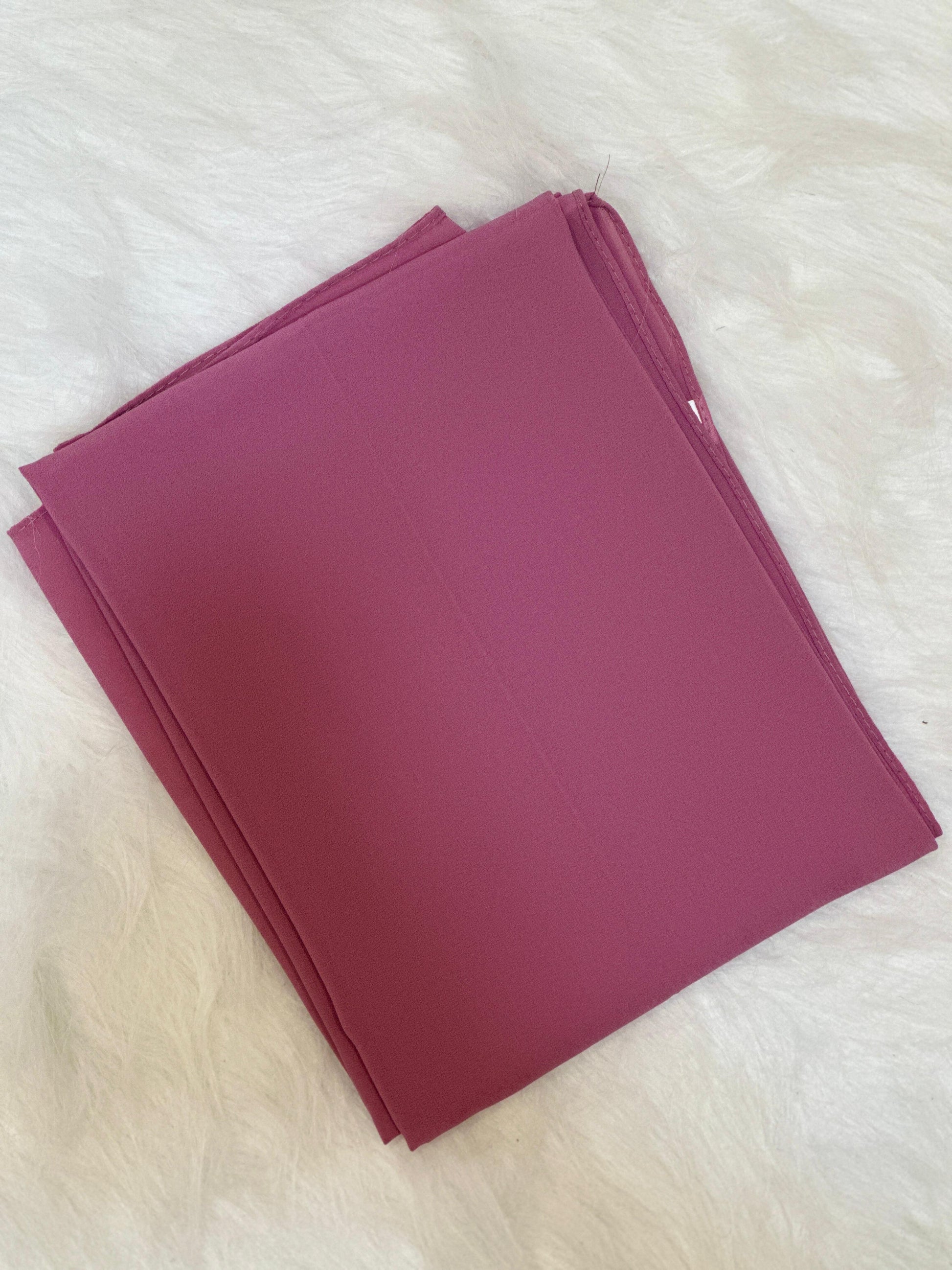 Puce chiffon scarf arranged neatly in a folded display for product view.