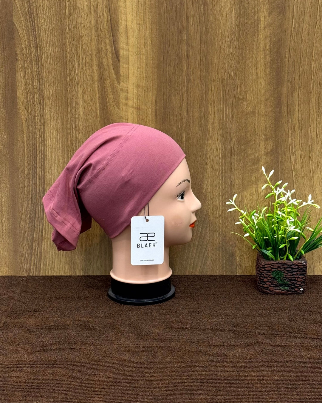 Side profile of puce hijab tube cap.