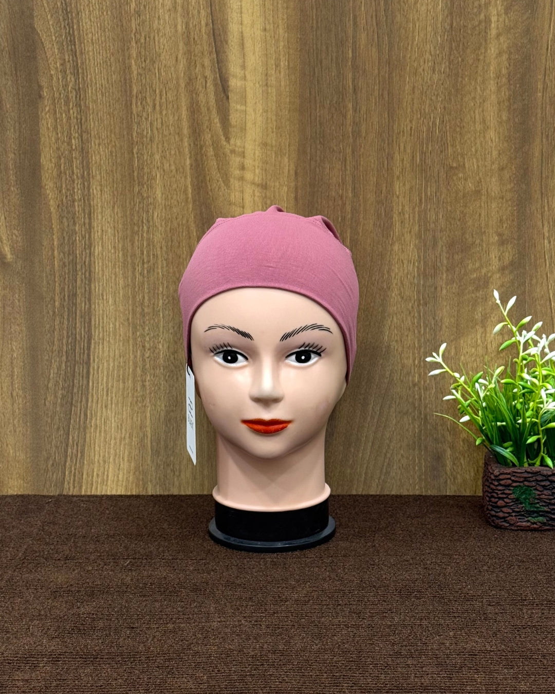 Puce tube cap front view on mannequin.