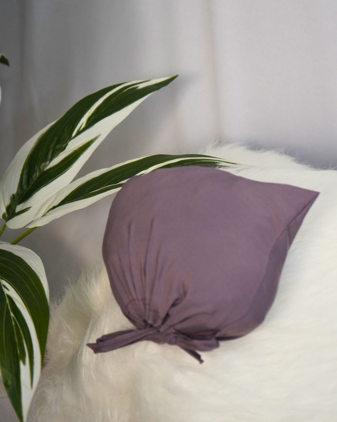 Matching solid purple pouch for Islamic prayer dress.