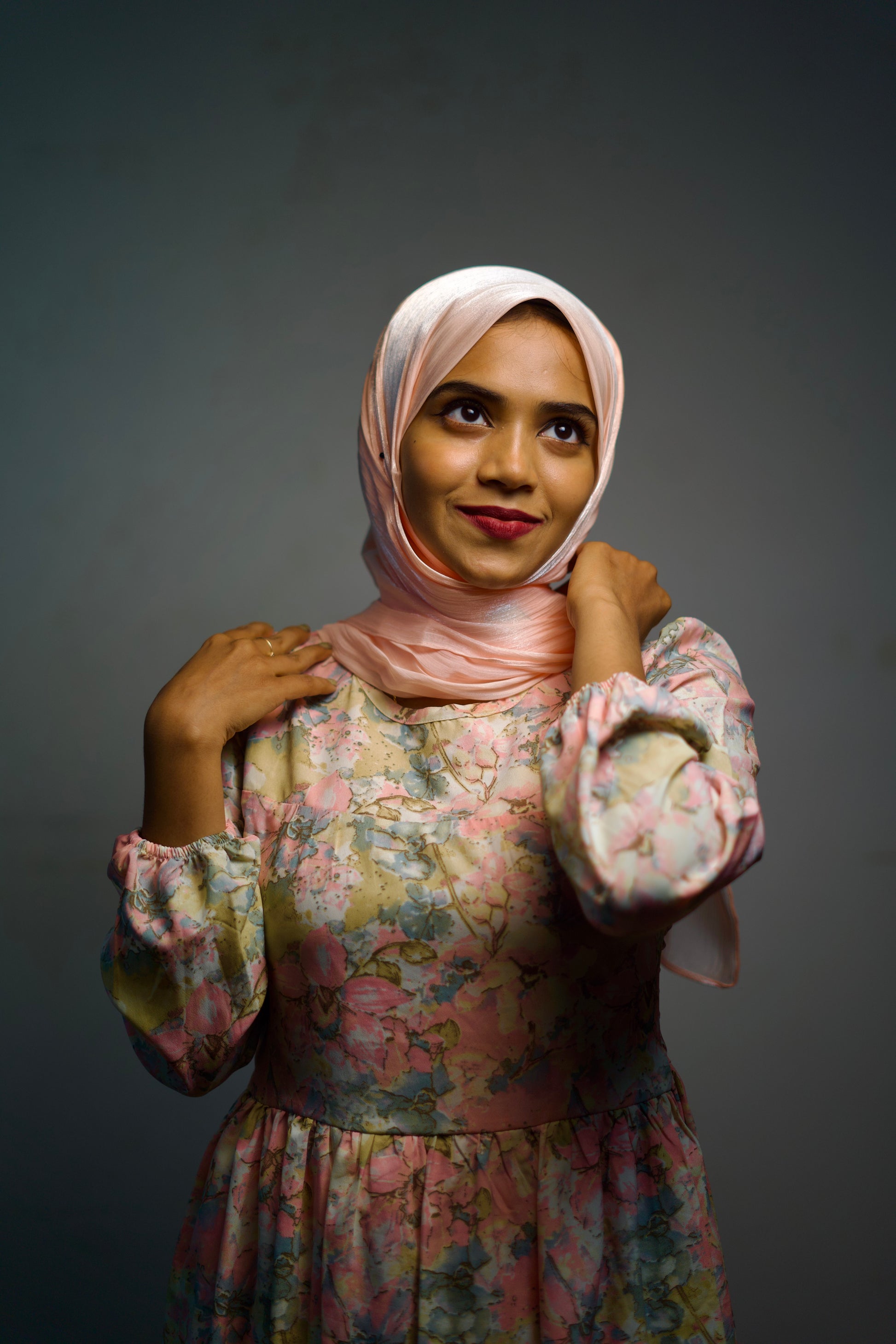 Shiny fabric of the Rose Gold Shimmer Hijab wrapped gently around the head.