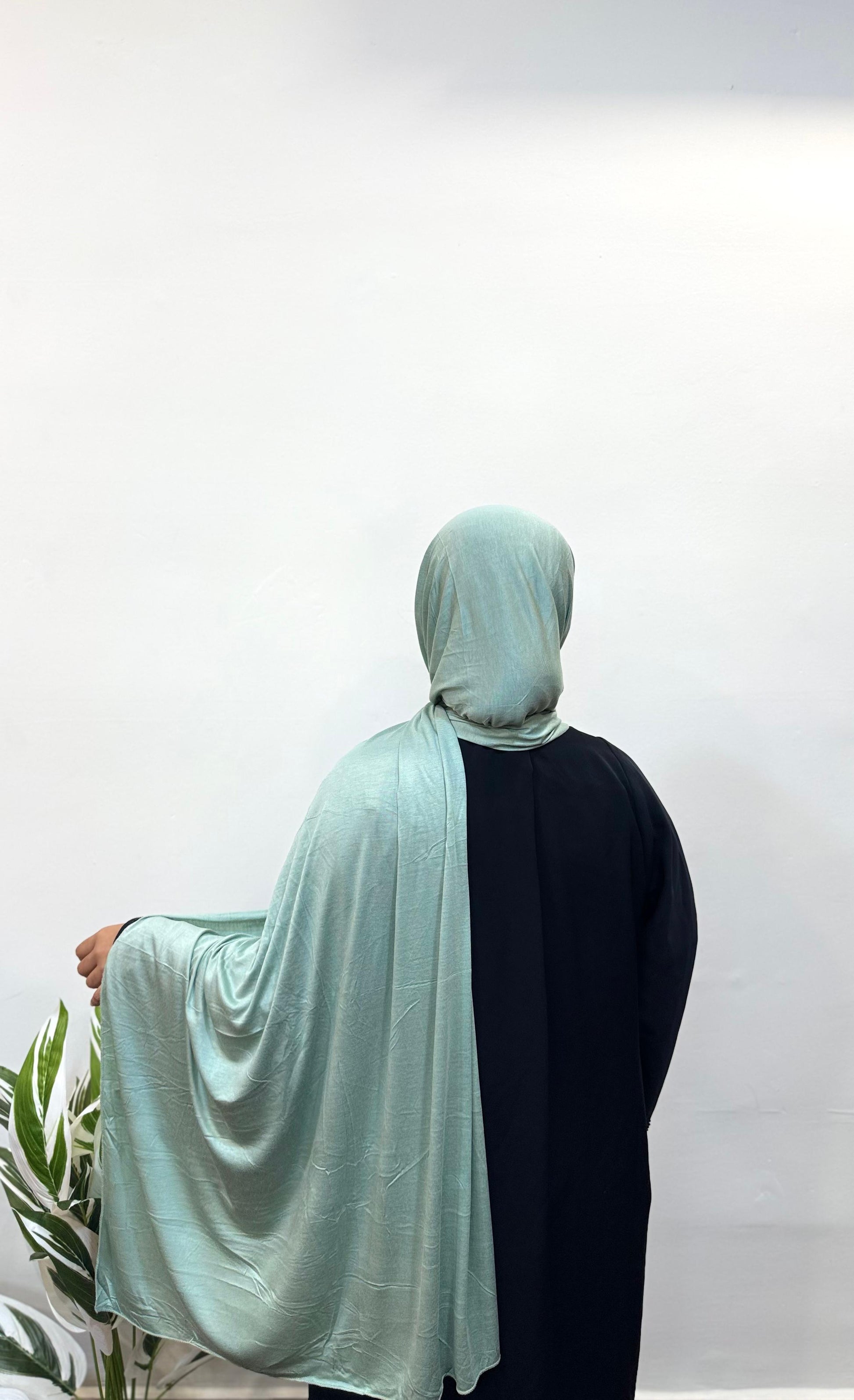 Seafoam green jersey hijab flowing softly down the back.
