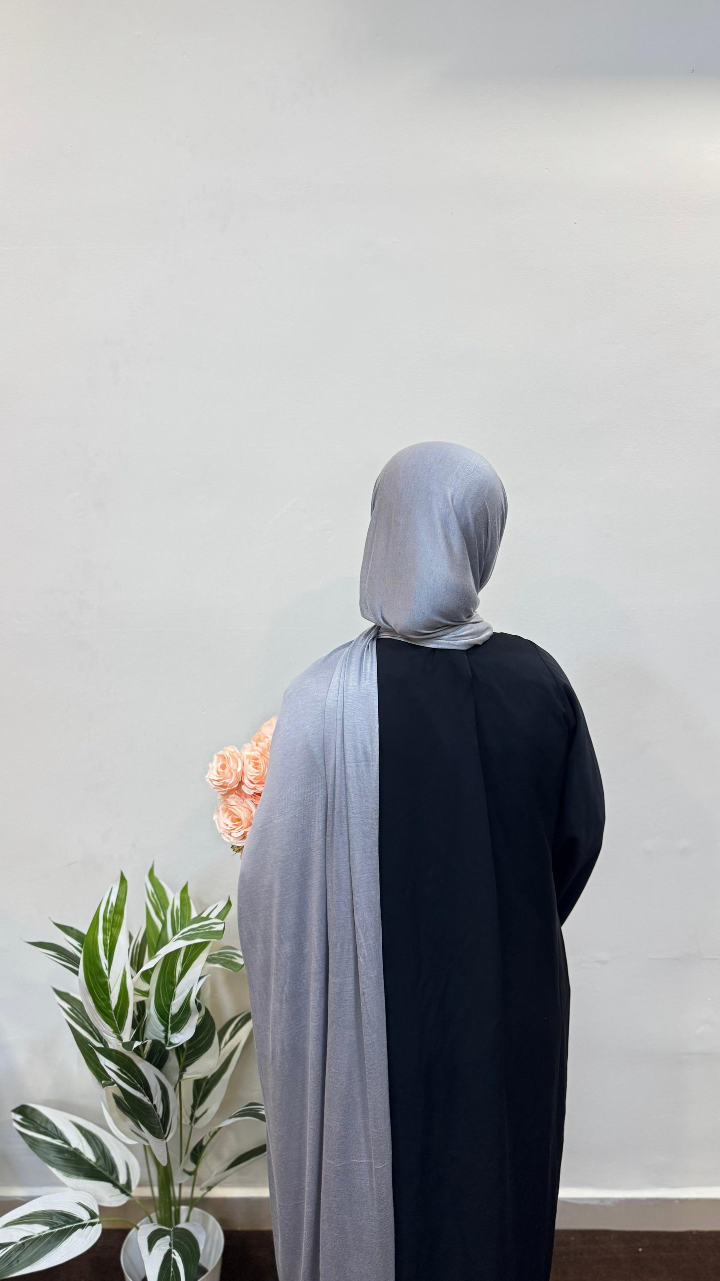 Silver jersey hijab flowing softly with a subtle sheen.