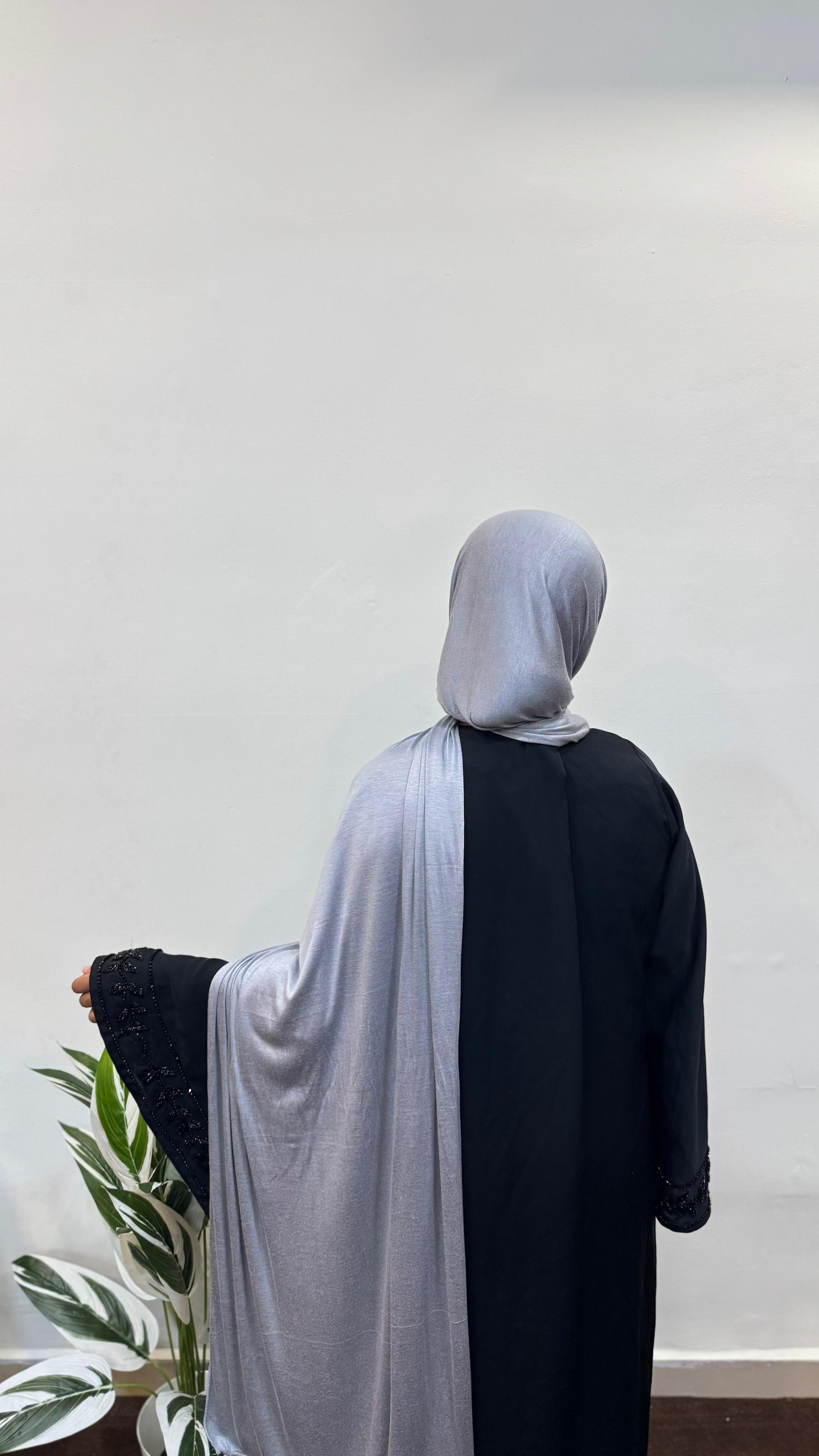 Silver jersey hijab draped gently around the head and shoulders.