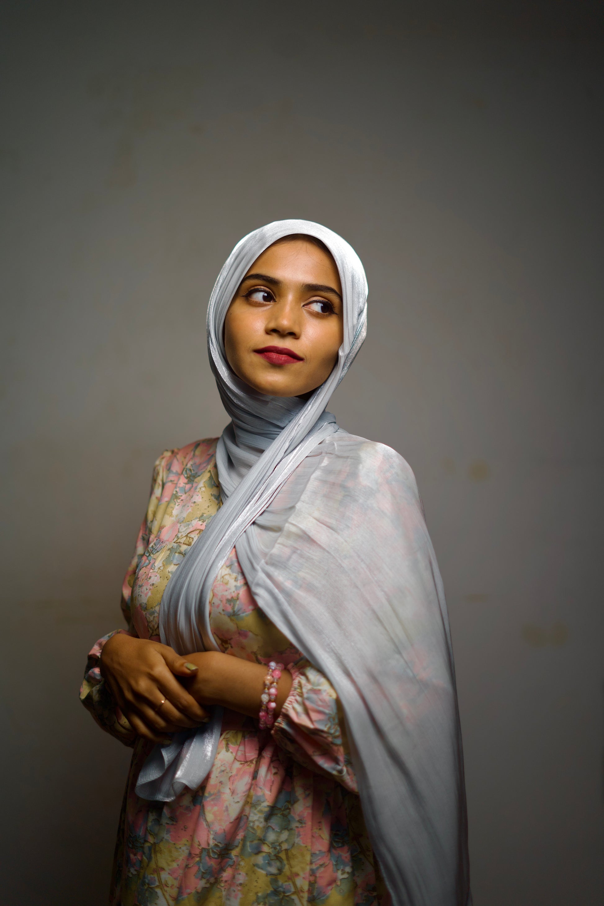 Chiffon hijab in silver shimmer, styled with smooth folds around the face.