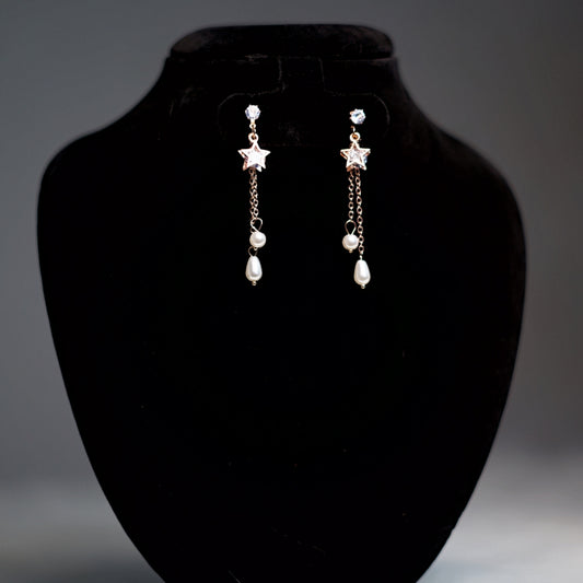 Lightweight statement earrings in rose gold with twin pearl drops and crystal-studded tops.