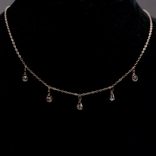 Rose gold stone drop chain necklace with five clear crystal teardrops.