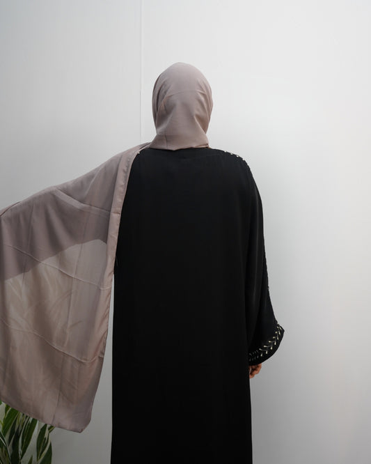 Side-extended view showing the semi-sheer drape of the taupe chiffon hijab.
