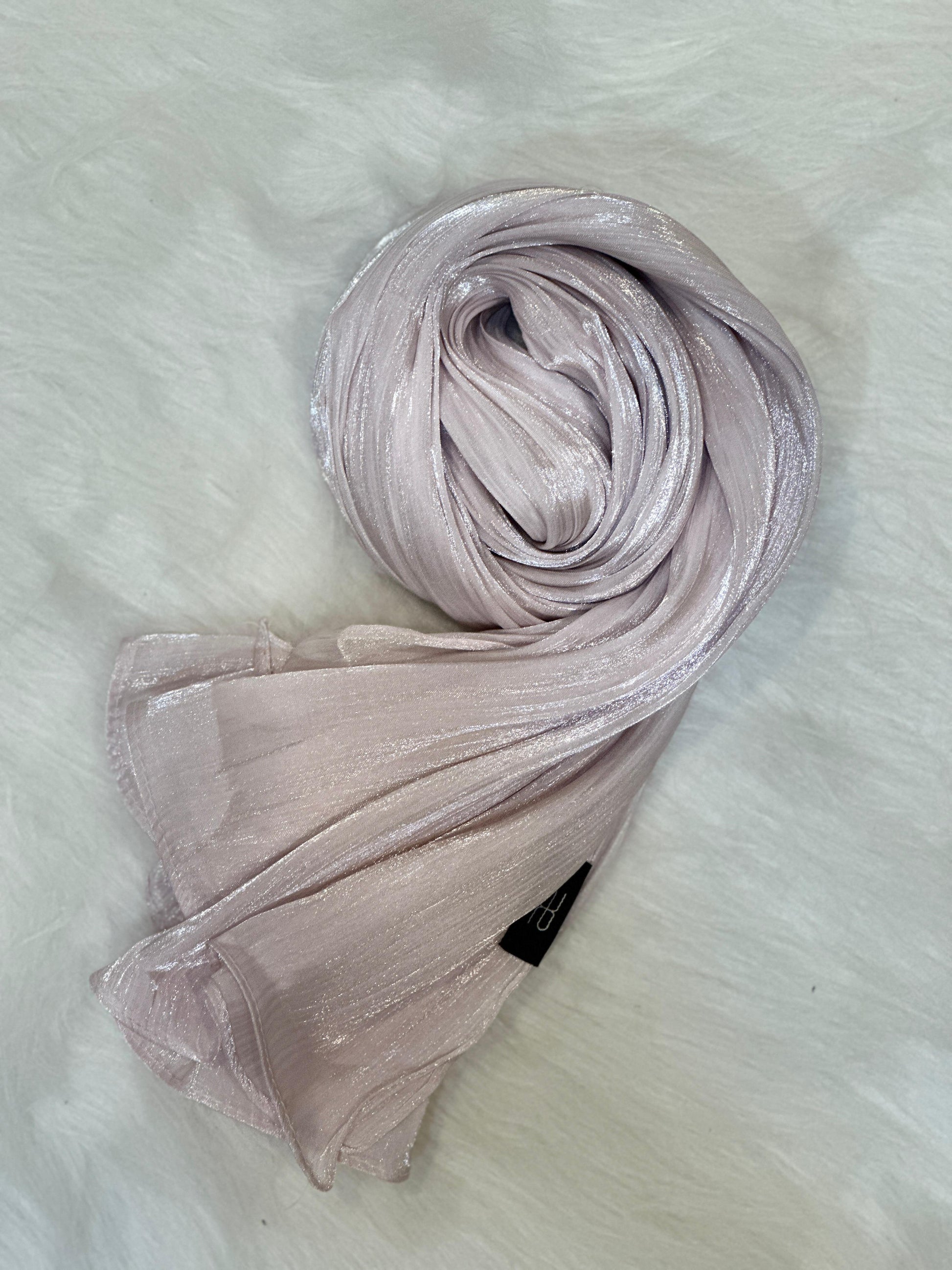 Thistle Shimmer Hijab rolled into a circular shape to show soft shimmer.