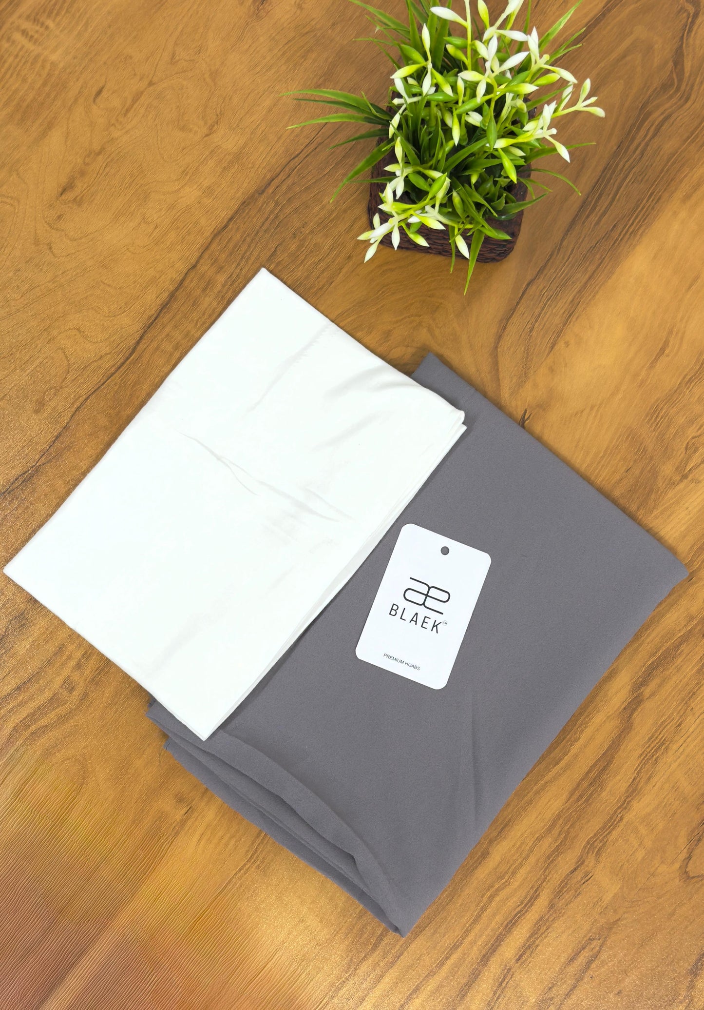 Lightweight smoke grey hijab with a fitted white cap for a polished look.