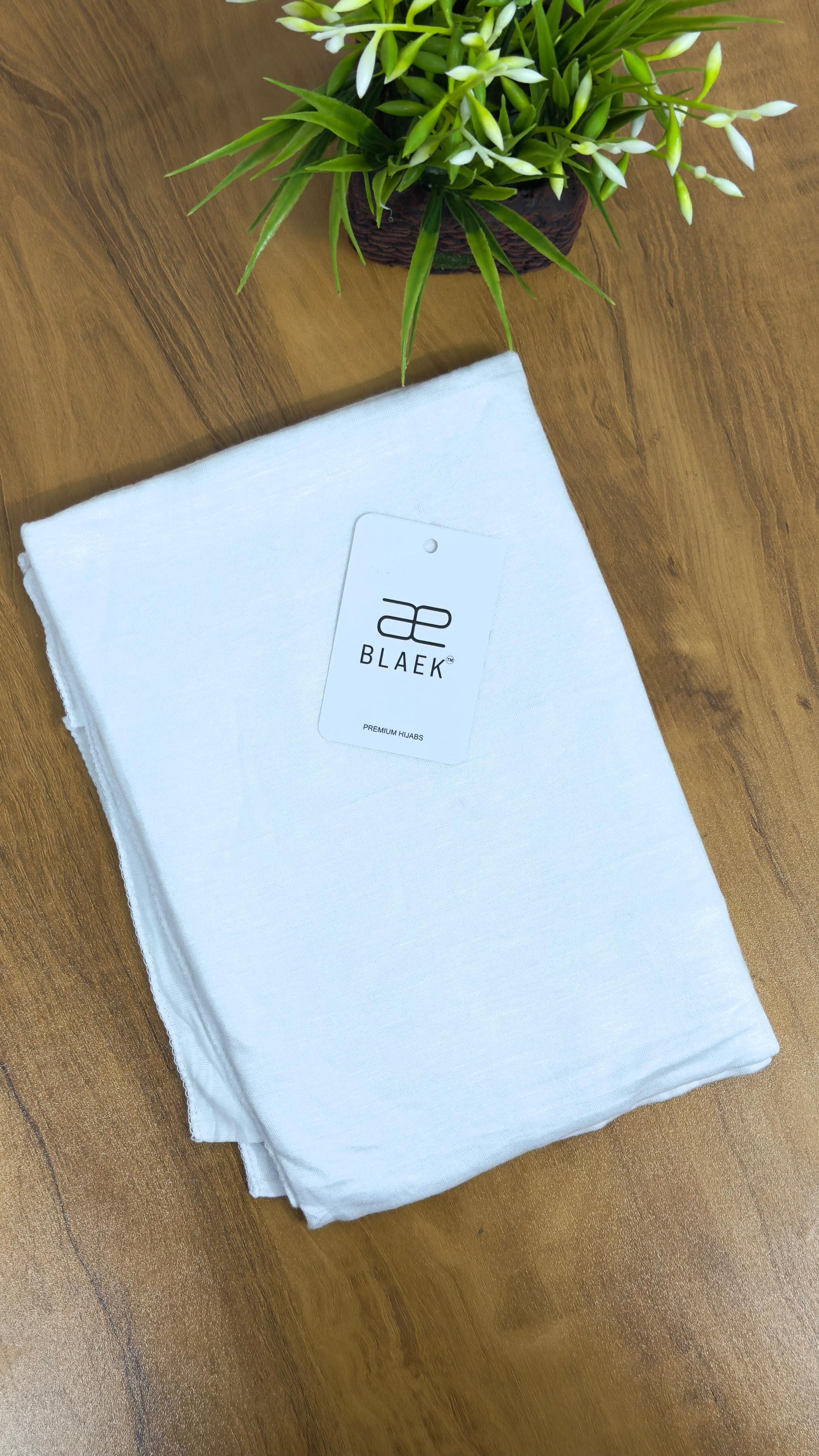 Smooth white hijab, arranged in a folded display.