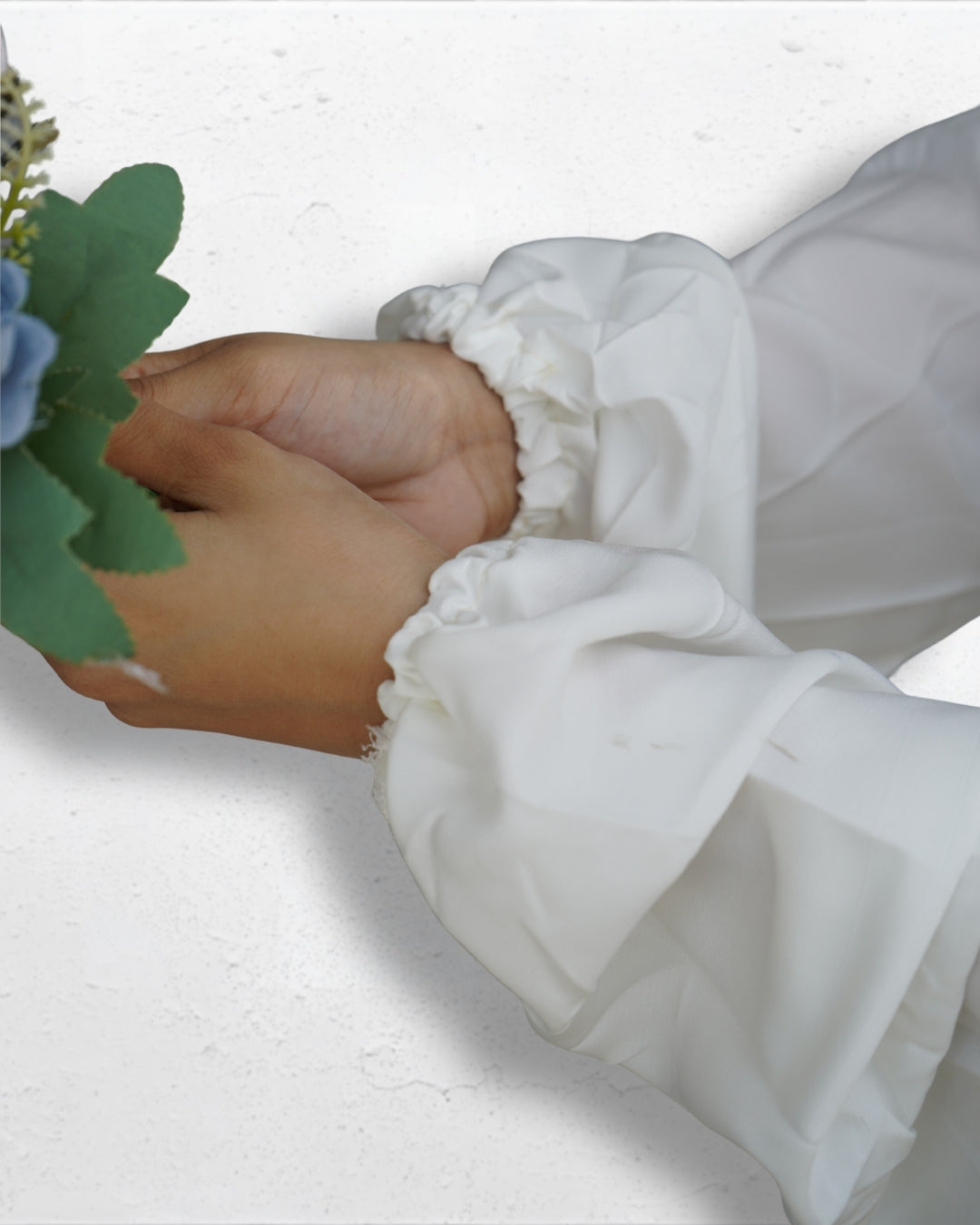 Elastic cuff detail of white modest Islamic prayer dress sleeve.