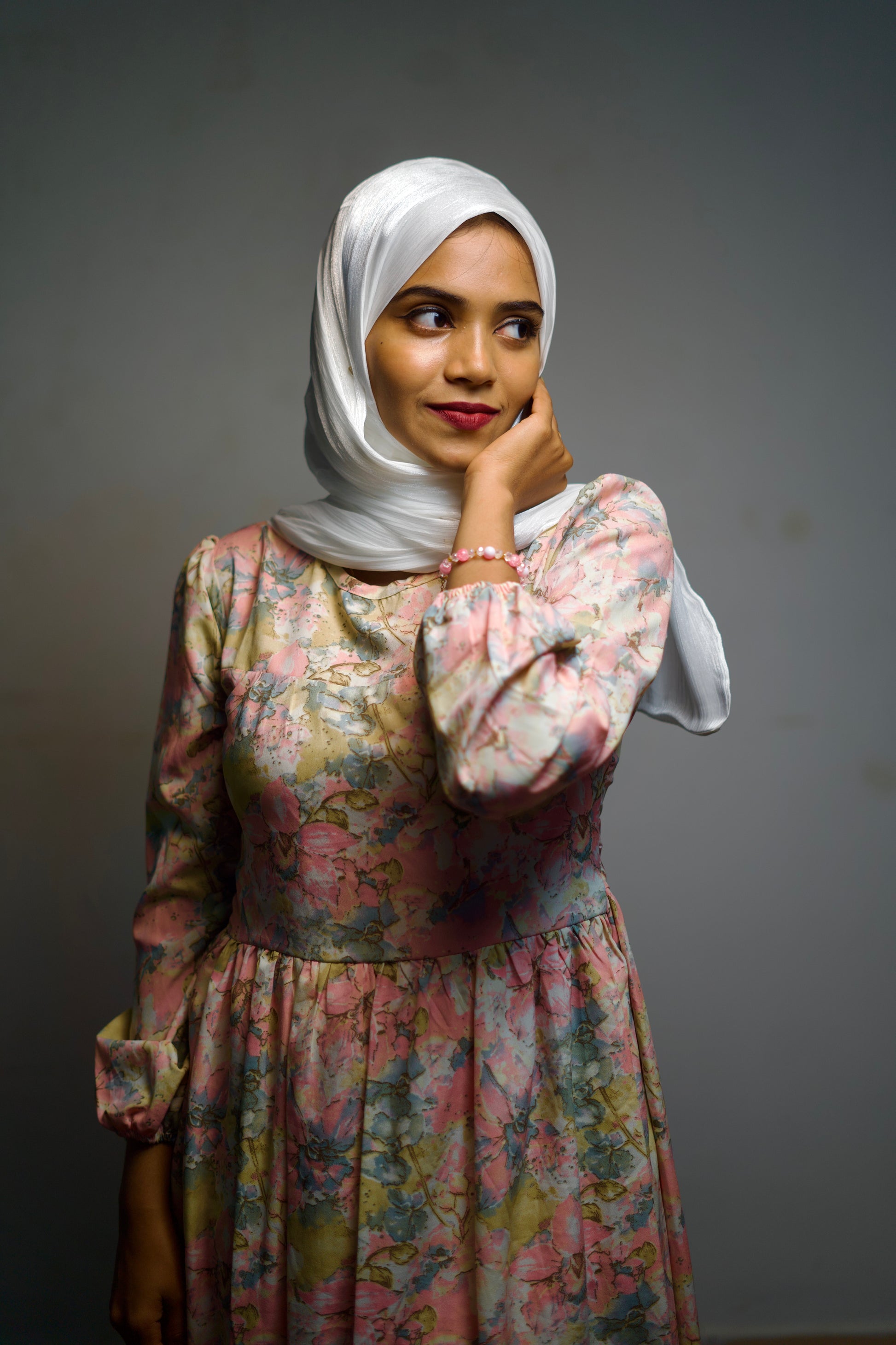 Woman in a white chiffon hijab with subtle shimmer, styled with grace.
