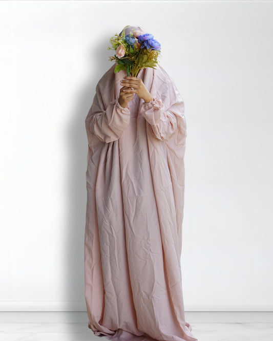 Beige prayer dress full length front view with floral bouquet.