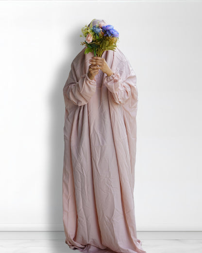 Beige prayer dress full length front view with floral bouquet.