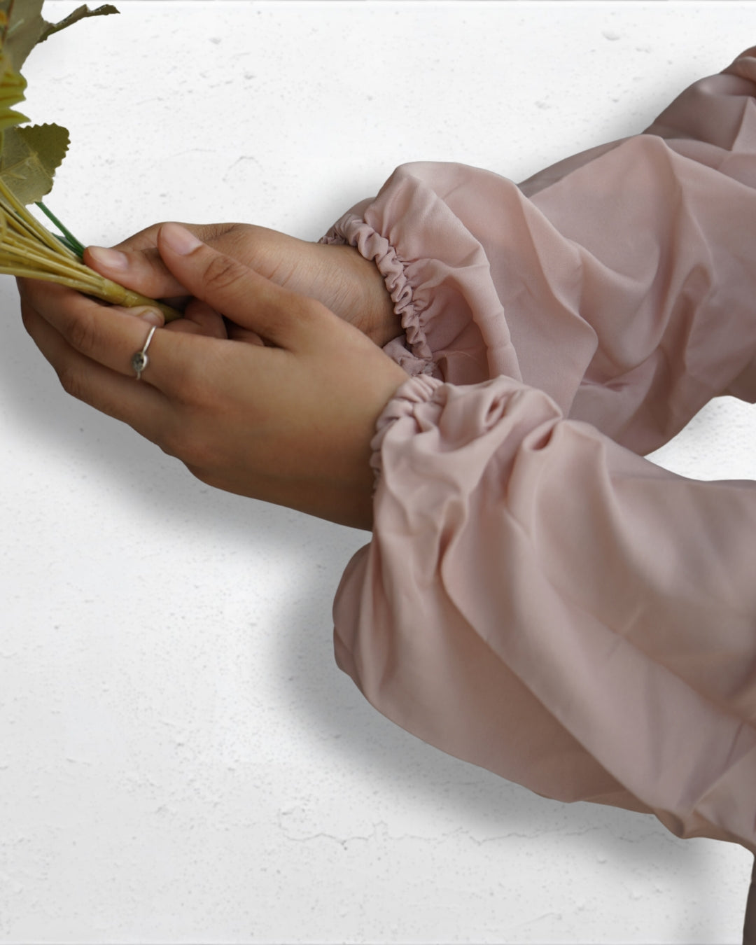 Elastic cuff detail of beige prayer dress sleeve.