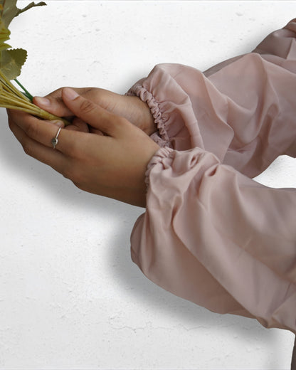 Elastic cuff detail of beige prayer dress sleeve.
