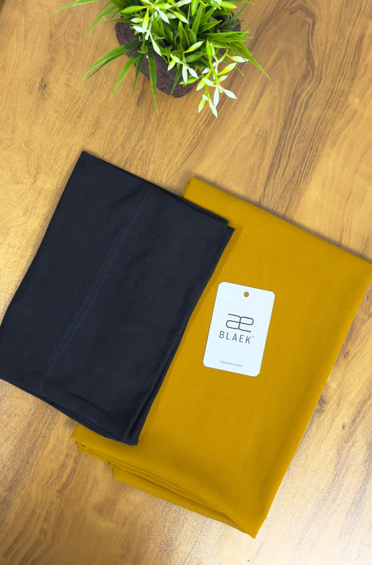 Vibrant mustard hijab paired with a sleek black cap for a bold contrast.