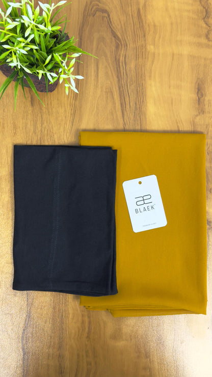 Golden mustard hijab with a classic black cap for effortless styling.