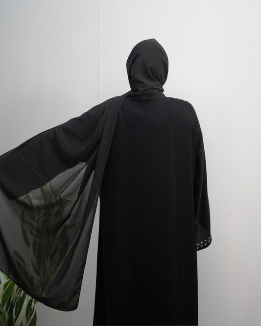Lightweight breathable black chiffon scarf with neat stitched edges.