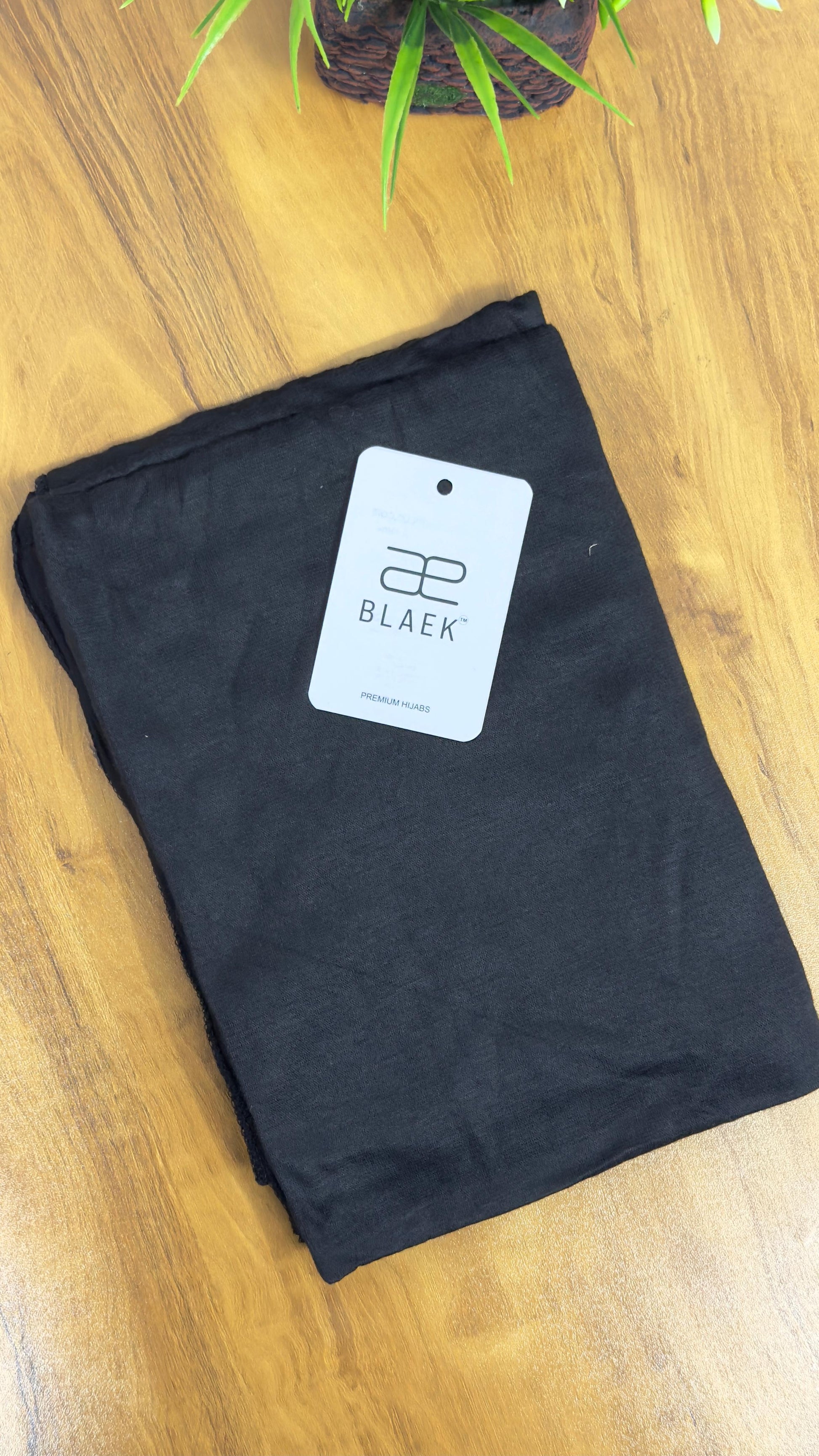Deep black hijab in soft, stretchy jersey fabric.