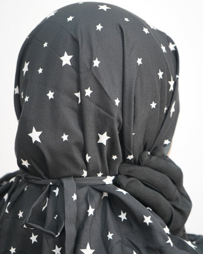 Back view of star print prayer dress showing adjustable tie at head.