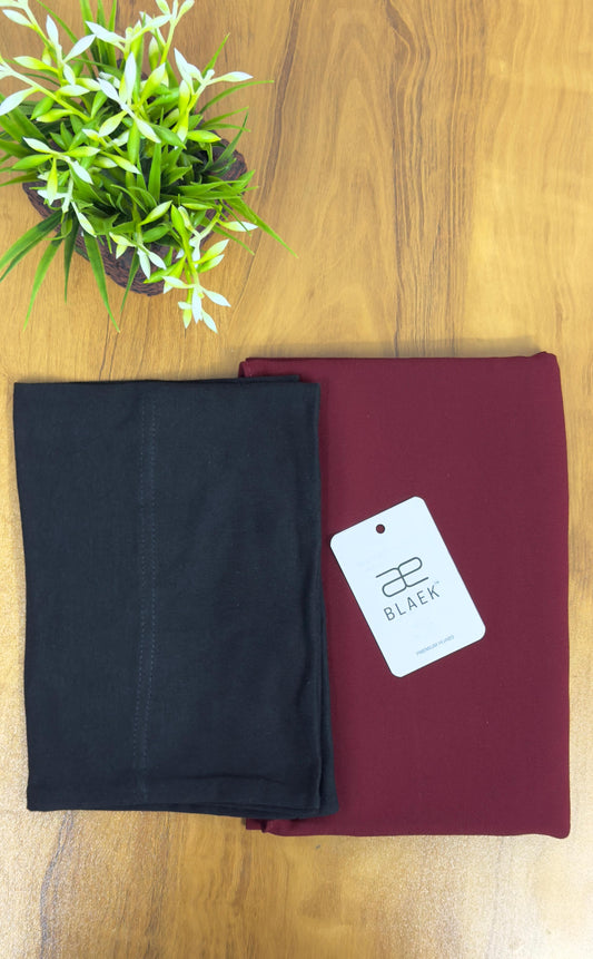 Deep cherry-toned hijab featuring a structured black cap for a refined touch.