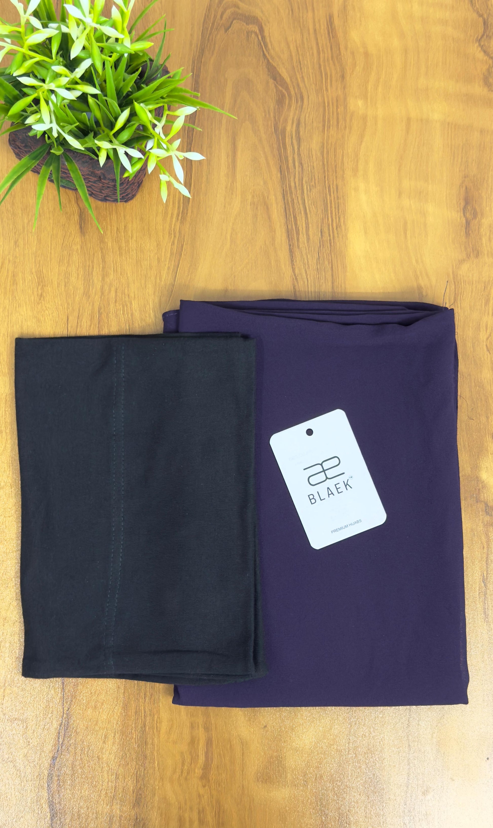 Dark purple eggplant hijab featuring a breathable black cap for all-day comfort.