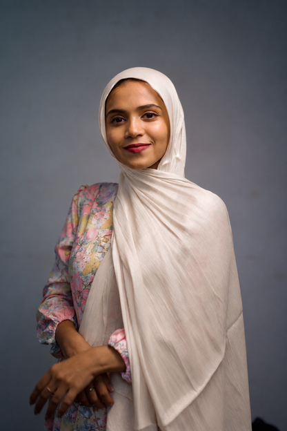 Woman wearing Blush Cream shimmer hijab with elegant draped styling
