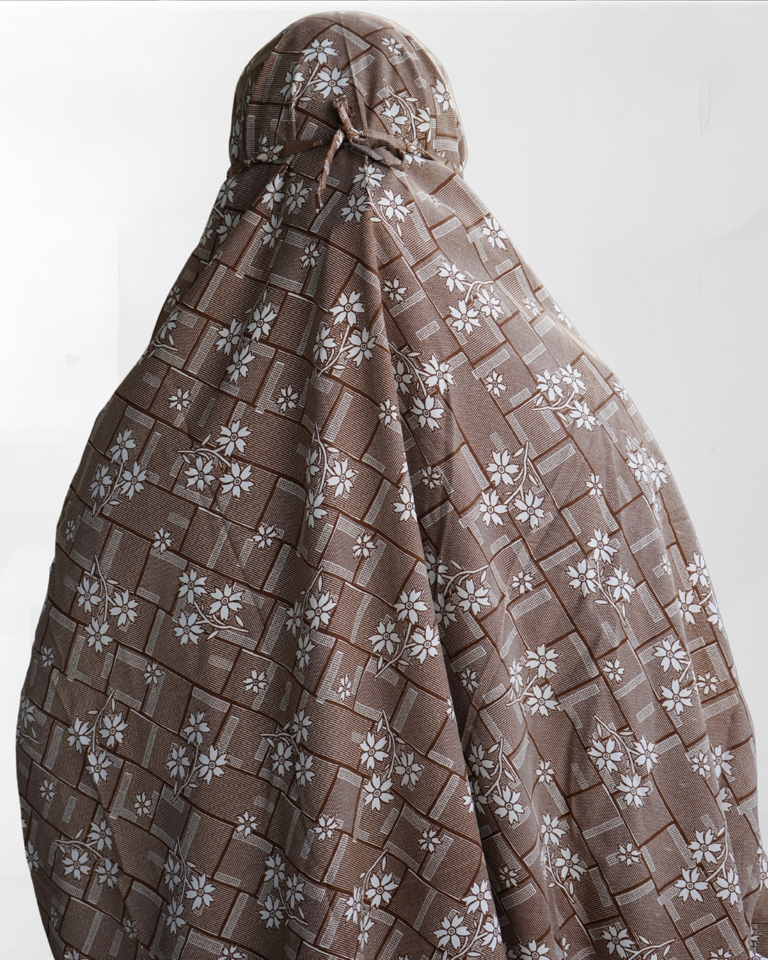 Back view of brown floral prayer dress with tie-back and full coverage.