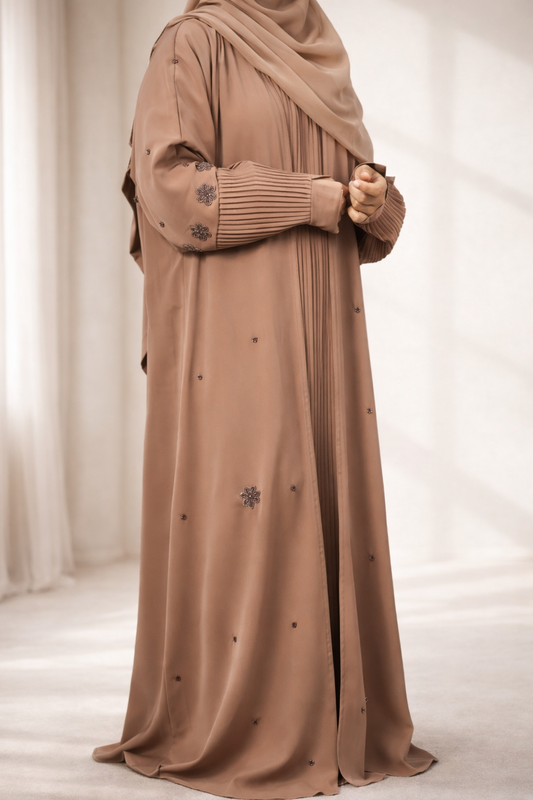 A full shot of the Korean Alqa Nidha Abaya in brown, hanging to showcase the overall design and length.