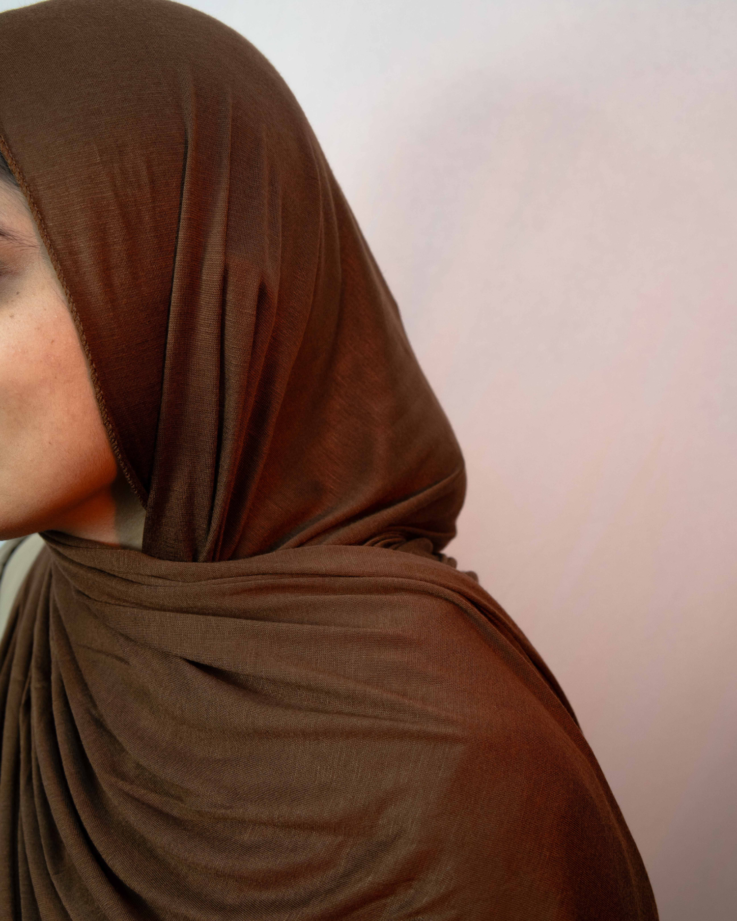 Close up chocolate brown jersey hijab soft fabric smooth drape modest scarf