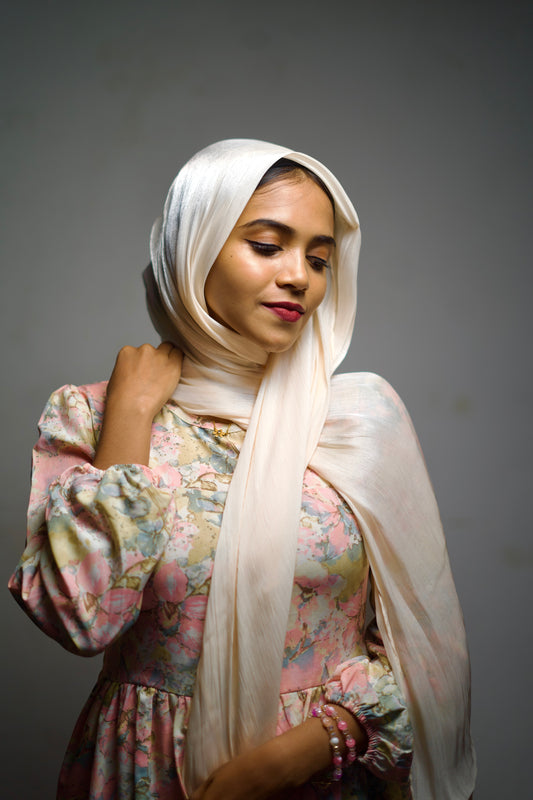 Cornsilk-toned chiffon hijab with a subtle shimmer, worn elegantly.
