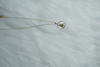 Crimson Leaf Necklace with red and green motif on white backdrop.