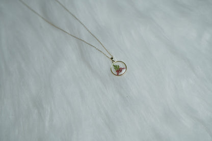 Close-up of Crimson Leaf Necklace showing red floral and leaf design.