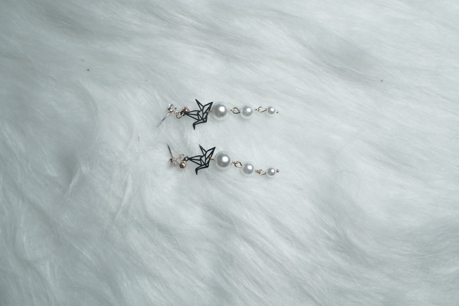 Crystal Origami Pearl Drop Earrings laid flat on clean background